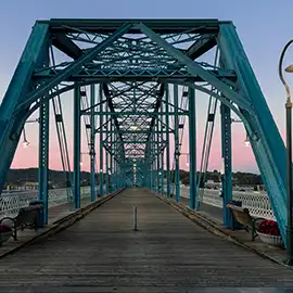 Walnut Street Bridge walkway and blue steel trusses at dusk in Chattanooga