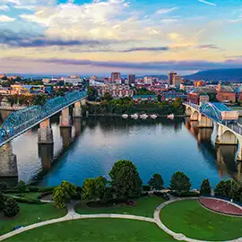 Aerial view of downtown Chattanooga skyline and Tennessee River bridges at sunset