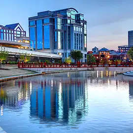 Downtown Huntsville skyline reflected in Big Spring Park lagoon at dusk