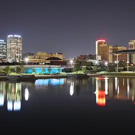 Birmingham, Alabama skyline lit up at night reflecting on the water