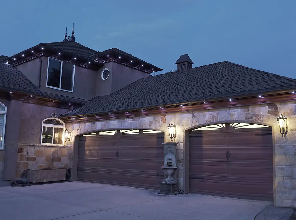 Warm layered landscape lighting illuminating a backyard patio and landscape at dusk by Newage Lights