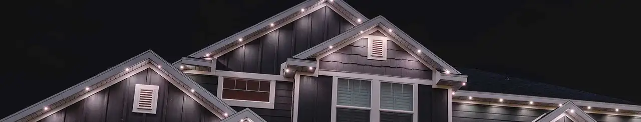 Professional holiday lighting installation on a home