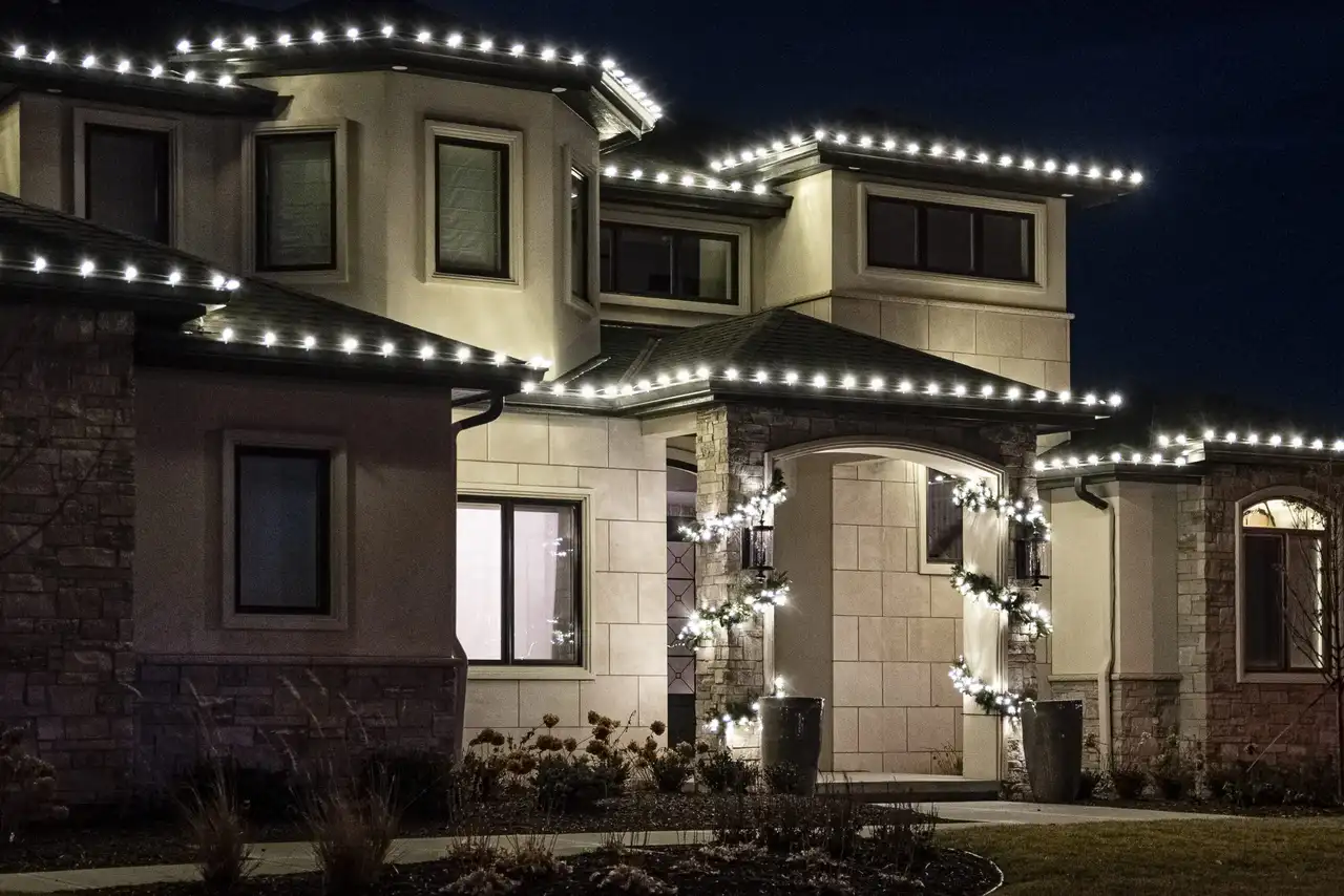 Home with permanent roofline lighting installed by Newage Lights glowing at dusk