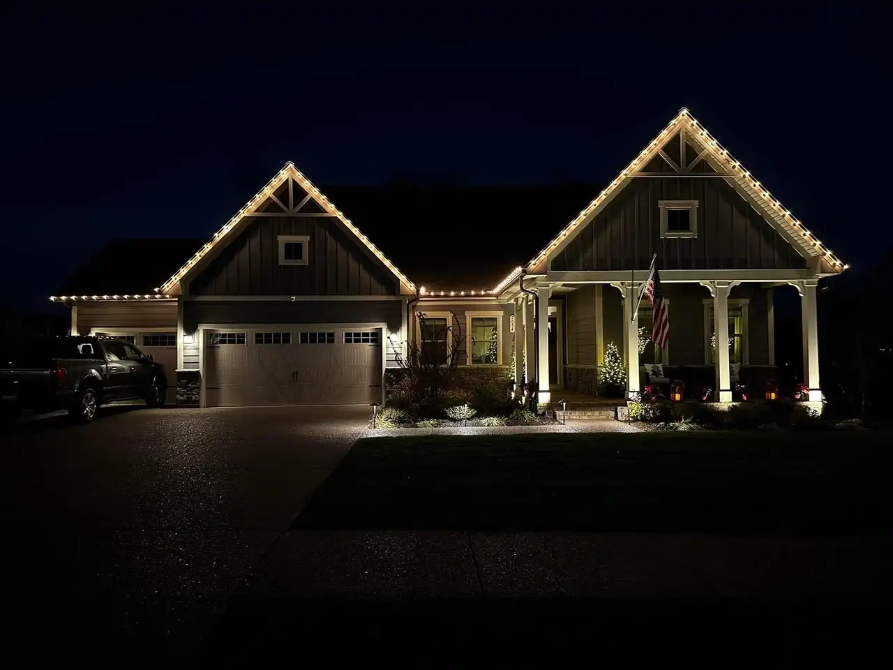 Craftsman-style home in Aldenwood Park, Knoxville at night with warm white permanent LED lighting outlining the gables and roofline